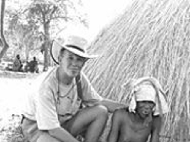 Pat Bradley with a Sudanese villager in front of her home