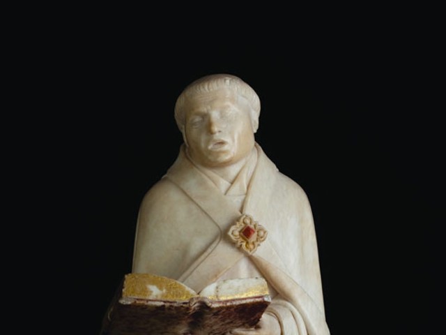 Jean de la Huerta and Antoine Le Moiturier, Mourner no. 48, cantor holding an open book in both hands, 1443&ndash;56/57, alabaster, 16.25 by 6.125 by 5.125 inches, Musee des Beaux-Arts, Dijon. &copy; FRAME (French Regional and American Museum Exchange) by Jared Bendis and Fran&ccedil;ois JAY