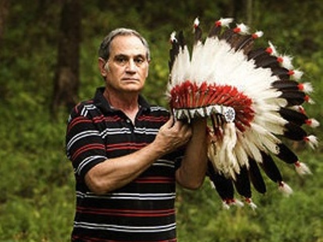 Kevin Airis with an eagle-feather headdress the Science Center returned to him in 2007.