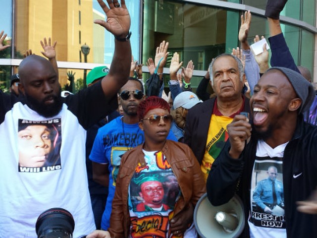 Michael Brown Sr., Lesley McSpadden and Pastor Carlton Lee in front of the Buzz Westfall Justice Center in Clayton Saturday.