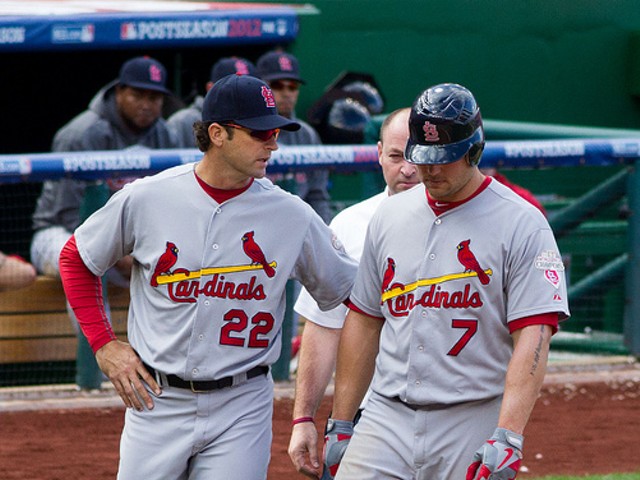 Mike Matheny walks with Matt Holliday at a National League Division series game in 2012.