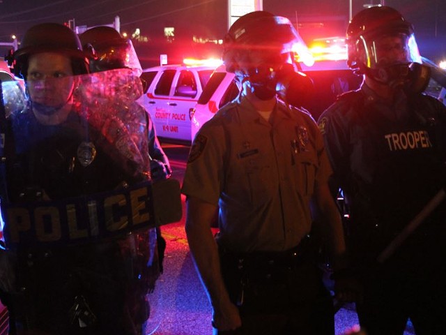 Police wore riot gear and used tear gas early Friday morning, like the officers in Ferguson during West Florissant Avenue protests.