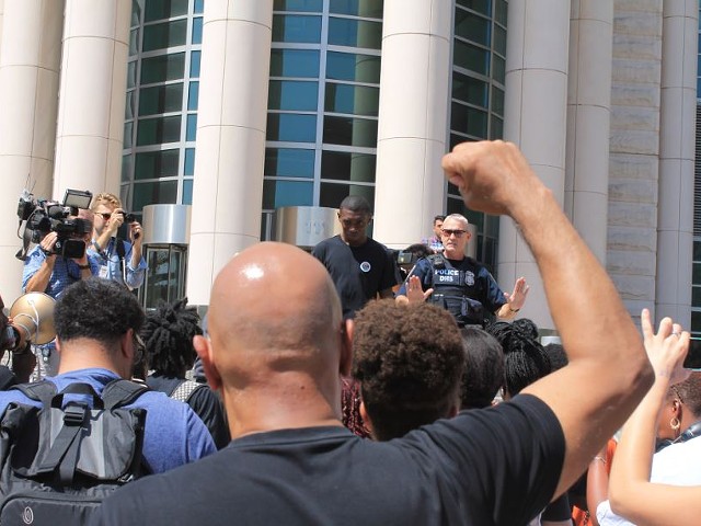 Protesters rally in front of the Thomas Eagleton Courthouse Tuesday.