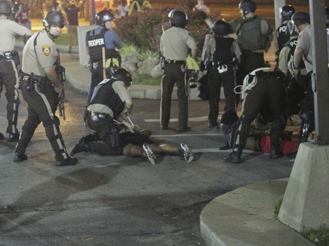 Police arrest protesters in Ferguson Monday night.