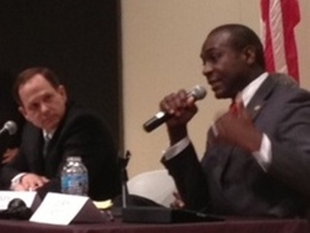 Francis Slay listens to Lewis Reed at a debate.
