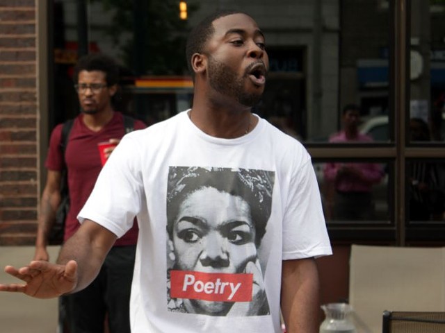 Corey Black, a St. Louis poet, throws down verses during a memorial to Maya Angelou Wednesday afternoon.