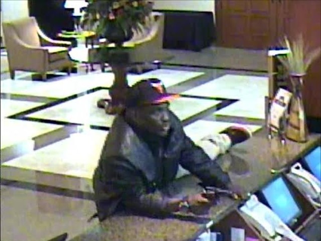 This still from the Drury Inn & Suites security camera footage shows the suspect who shot and killed a night manager. Police say the man was wearing a Chicago Bulls ball cap, a black or brown leather waist-length coat, a black tee shirt with white "Adidas" logo across the front and khaki pants.
