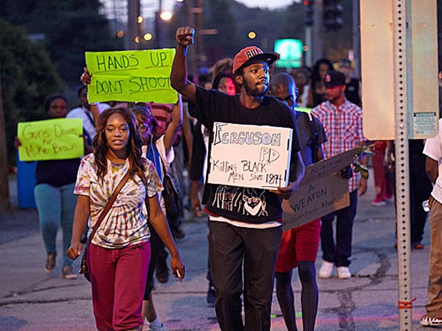 Protesters march in Ferguson on August 18.