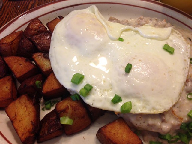 Country fried steak topped with gravy and two eggs, plus home fries. | Nancy Stiles