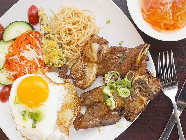 Com Tam Dac Biet includes a grilled honey-glazed lemongrass pork chop, a fried egg, a Vietnamese egg cake and shredded pork skin with broken rice.