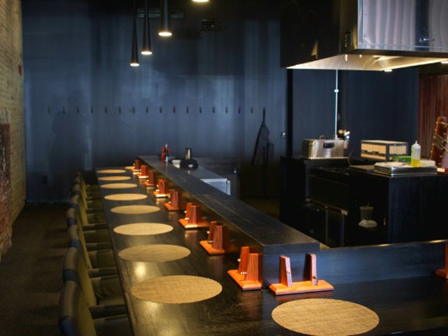 Diners sit around the kitchen for an interactive experience.