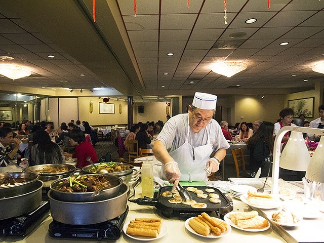 The chef at Mandarin House works a griddle in the middle of the dining room.
