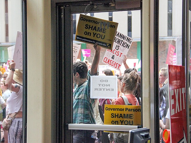 Protesters opposing new abortion restrictions gather outside the Wainwright Building last week.