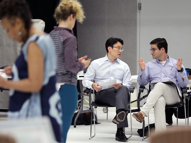 From left, doctors Albert Kim and Eric Leuthardt discussing BrainWorks.