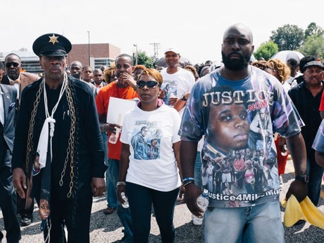 Lezley McSpadden, center, Michael Brown's mother, and Michael Brown Sr., right.