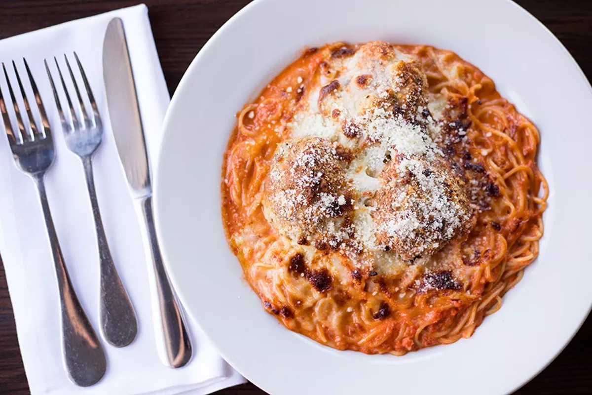 Spaghetti alla Angela" is topped with meatballs with baked provolone and Parmigiano cheese.