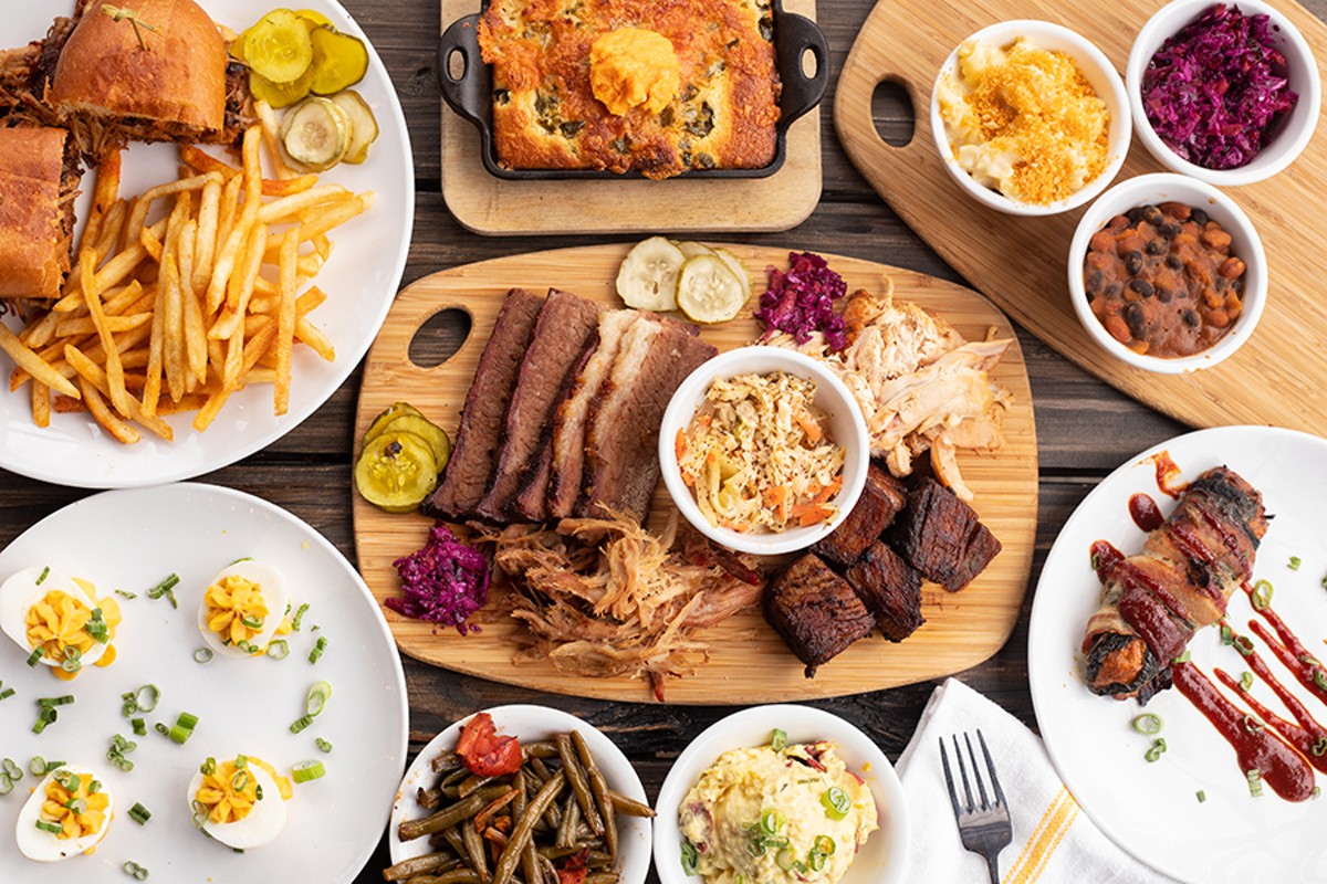 A selection of items from Knockout BBQ, pictured from left to right, top to bottom: loaded pulled pork sandwich, jalapeño-blueberry cornbread, mac 'n' cheese, slaw, pit beans, deviled eggs, meat combo, Texas Twinkie, roasted green beans and tomatoes and egg and mustard potato salad.