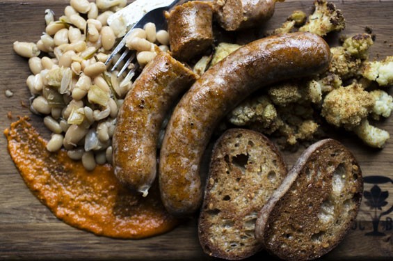Hungarian bratwurst alongside roasted cauliflower, cider marrow beans, wheat toast and romesco sauce. See photos: Urban Chestnut Serves Delicious Eats as well as Craft Beer in The Grove