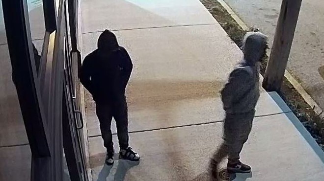 Surveillance footage shows two young men outside a restaurant just before they allegedly broke in.
