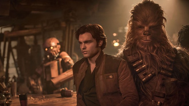 Han and Chewie (Alden Ehrenreich and Joonas Suotamo) hang out at a bar.