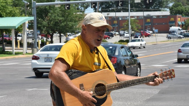 Roger 'Guitar Man' Ulrich playing a backup guitar after his was stolen on Monday.