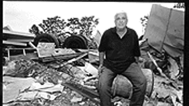 Marvin Andrew, co-owner of A-1 Iron and Metal, rests uneasily on the rubble left behind by a company headed by former state Rep. Tony Ribaudo.