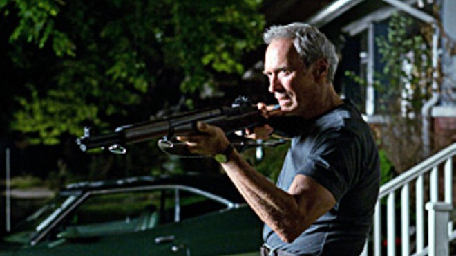Clint Eastwood takes aim at the neighborhood gang in Gran Torino.