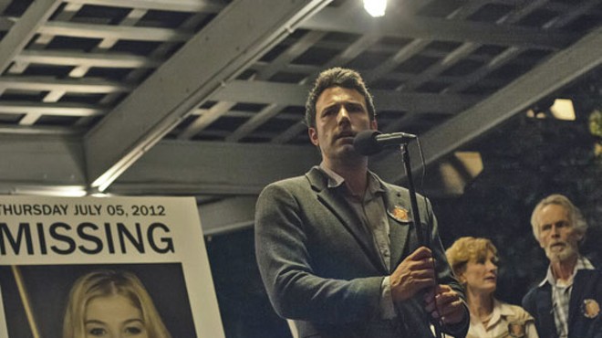 Nick Dunne (Ben Affleck) finds himself the chief suspect behind the shocking disappearance of his wife Amy (Rosamund Pike), on their fifth anniversary in Gone Girl.