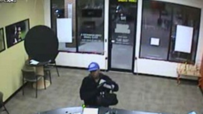Surveillance still of Chrice Shunta Combs robbing a Cash Store payday loan shop in Southern Illinois in 2010.