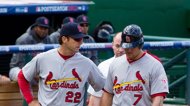 Mike Matheny walks with Matt Holliday at a National League Division series game in 2012.