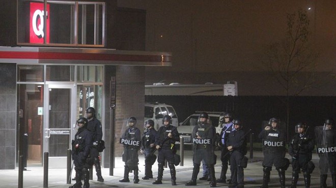 St. Louis cops in riot gear guard a QuikTrip in the Grove on October 12. Three days before, an officer shot and killed eighteen-year-old Vonderrit Myers Jr.