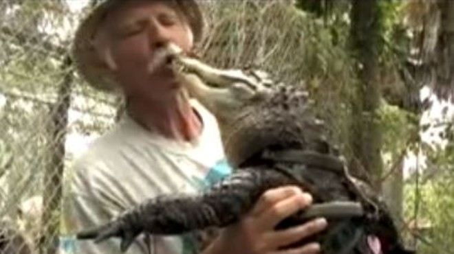 Ken Henderson, the "Gator Educator," doesn't mind showing affection to his reptile friends.