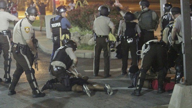 Police arrest protesters in Ferguson Monday night.
