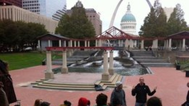 Zach Chasnoff, in black, speaks to a group gathered to commemorate the one-year anniversary of Occupy STL.