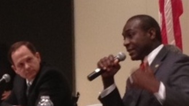 Francis Slay listens to Lewis Reed at Tuesday's debate.
