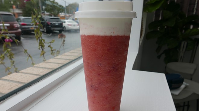 The layer of cream cheese sits in stark contrast to the strawberry slush.