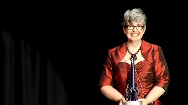 Shrewsbury resident Ann Leckie holds up her Hugo Award for Best Novel at the World Science Fiction Convention in London on August 17.