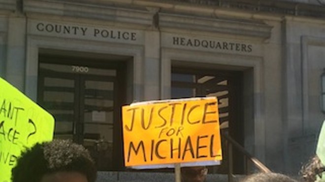 Protesters demand justice for Michael Brown's death Tuesday morning at the St. Louis County Police station in Clayton