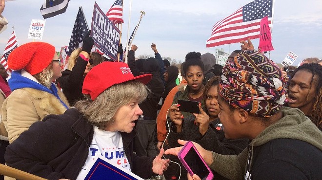 Trump supporters and critics debate outside a campaign rally in November 2017.