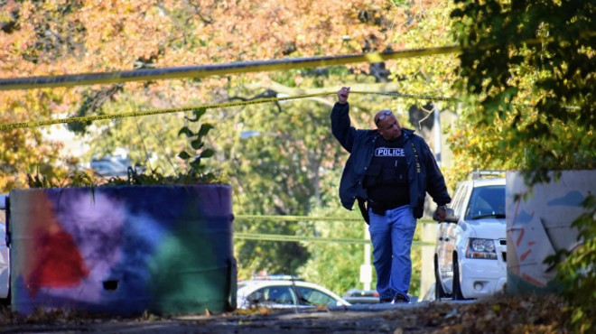 A St. Louis police officer walks onto the scene where a retired sergeant was killed this morning.