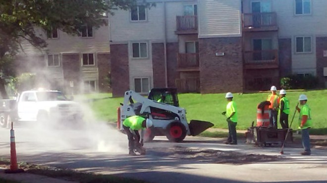 A crew paid for by the Lipton Group takes out the chunk of pavement.