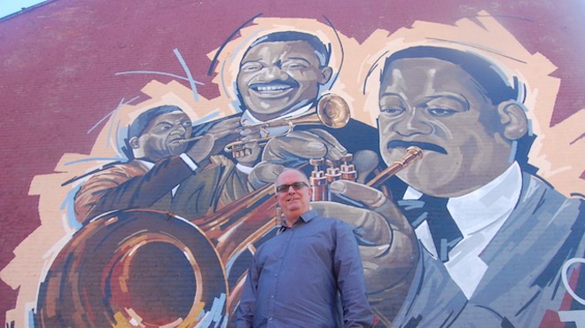 Artist Ray Harvey in front of his mural.