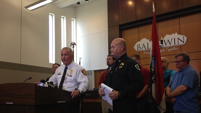 St. Louis County police Chief Jon Belmar (l) and Ballwin police Chief Kevin Scott say an officer was ambushed during a traffic stop on Friday.