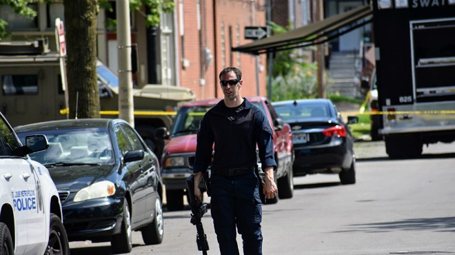 An officer leaves the scene of a five-hour standoff in Tower Grove South.