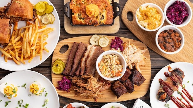 A selection of items from Knockout BBQ, pictured from left to right, top to bottom: loaded pulled pork sandwich, jalapeño-blueberry cornbread, mac 'n' cheese, slaw, pit beans, deviled eggs, meat combo, Texas Twinkie, roasted green beans and tomatoes and egg and mustard potato salad.