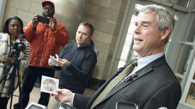 St. Louis County Prosecuting Attorney Bob McCulloch holds a CD containing surveillance footage from Ferguson Market on the day of Michael Brown's death.