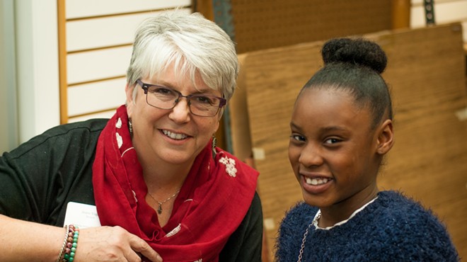 Jeane Vogel meets with Divine Robinson, a fourth grader at Washington Elementary, on interview night.