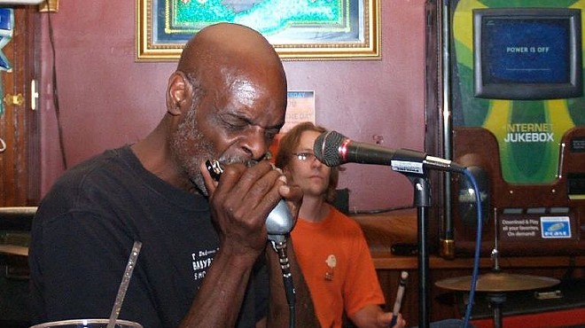 Eric McSpadden performing. The blues musician is known for his harmonica work.