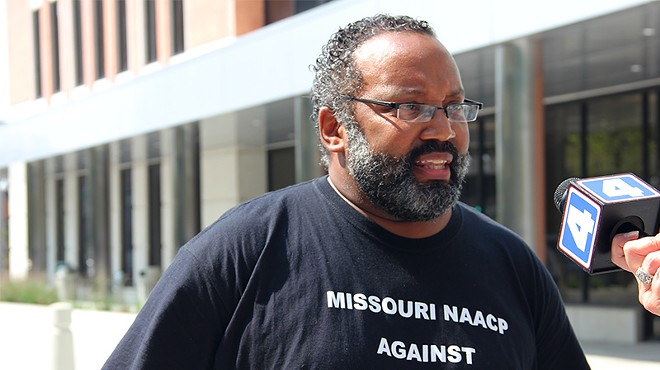 NAACP president Nimrod Chapel at today's press conference. His t-shirt references a new Missouri law increasing the burden for proving workplace discrimination.