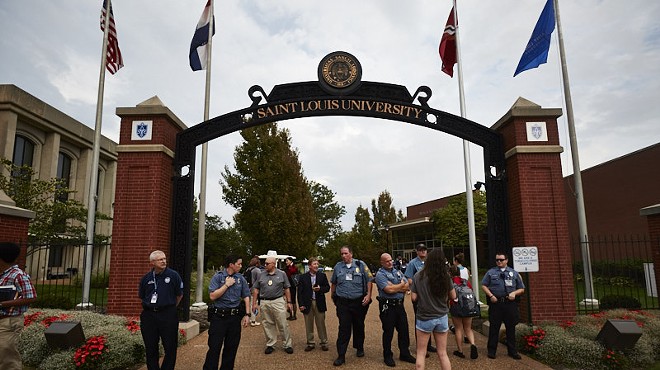 Police at St. Louis University posted at campus entrances during Sunday's protest march.
